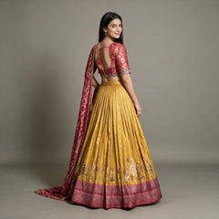 Back view of mustard Banarasi lehenga with open-back rani pink blouse and tie, worn