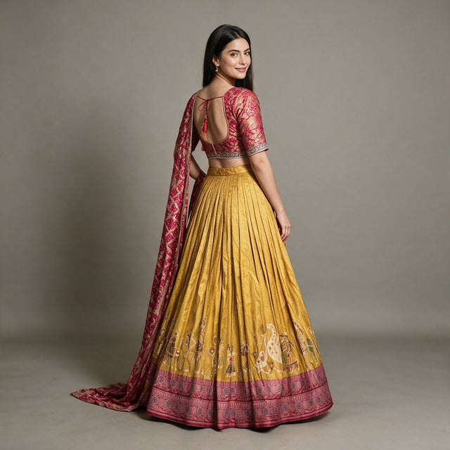 Back view of mustard Banarasi lehenga with open-back rani pink blouse and tie, worn