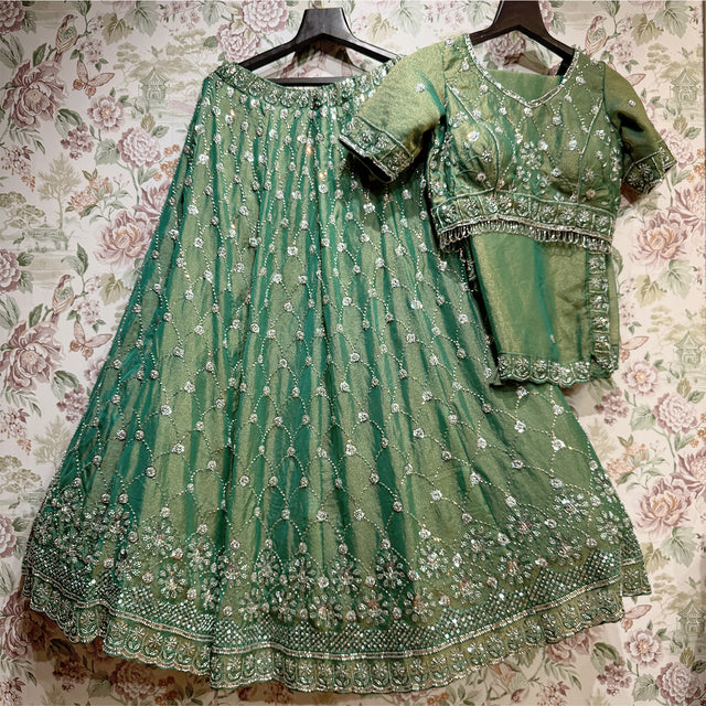Green lehenga and matching short-sleeve blouse set with bead and pearl embroidery