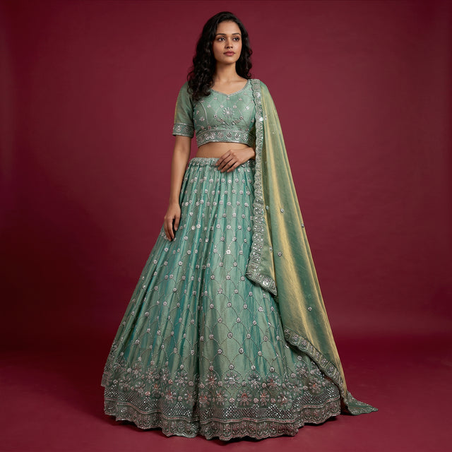 Green embroidered lehenga with matching blouse and draped dupatta, bead and pearl detailing