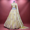 Butter yellow silk lehenga with pink and silver floral beadwork, full flare and dupatta