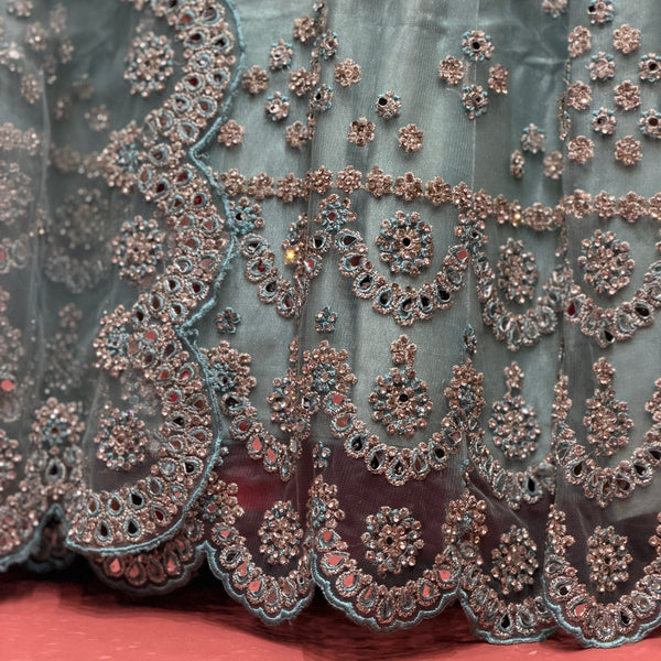 Sky blue net lehenga close-up of mirror and stone embroidery with scalloped lace trim