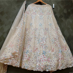 Cream bead-and-sequin lehenga with large floral motifs and sheer dupatta, full skirt