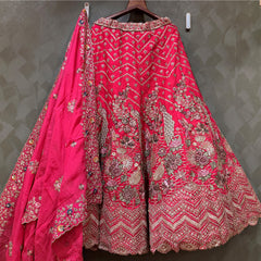 Rani pink bridal lehenga skirt with ornate silver embroidery and wide embellished hem
