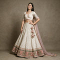 Ivory georgette Lucknowi lehenga with pink velvet patchwork hem, heart latkans and pink net dupatta, worn