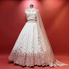 Ivory lehenga with pink and gold scalloped hem and embroidered bodice detail