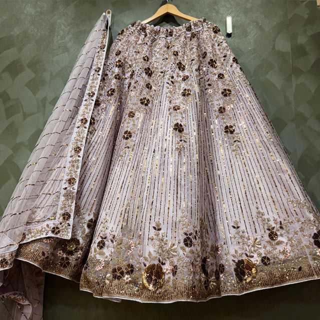 Lavender net lehenga with allover sequin stripes, floral embroidery, and gold trim