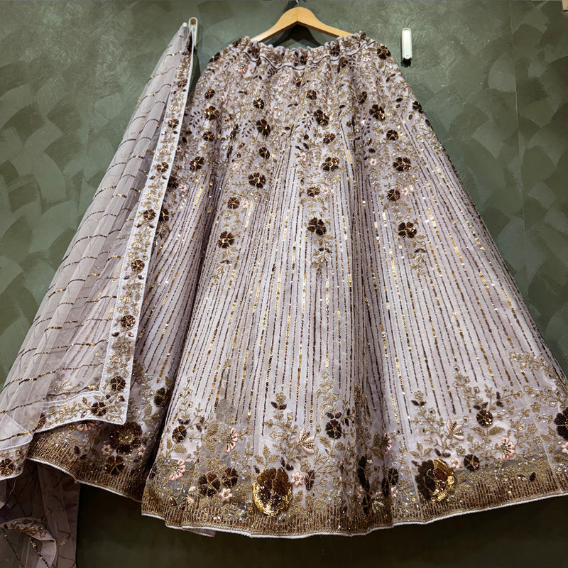 Lavender net lehenga with allover sequin stripes, floral embroidery, and gold trim