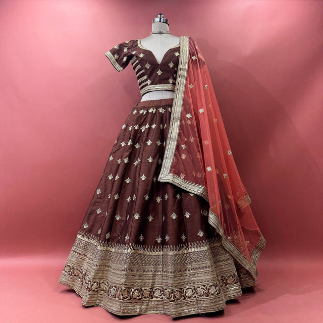 Chocolate brown raw silk lehenga set with blouse and net dupatta on mannequin