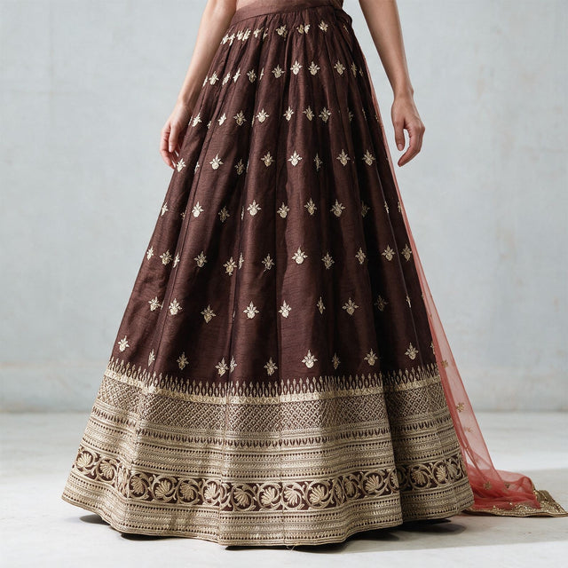 Chocolate brown raw silk lehenga skirt with scattered gold butis and layered gold embroidered hem