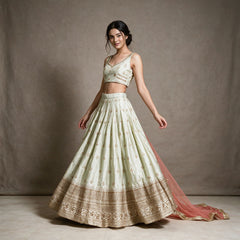 Pista green raw silk bridesmaid lehenga with gold butis and embroidered hem, worn with net dupatta