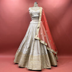 Silver grey raw silk lehenga set with blouse and net dupatta on mannequin