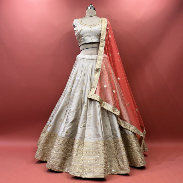 Silver grey raw silk lehenga set with blouse and net dupatta on mannequin