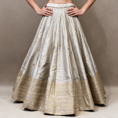 Silver grey raw silk lehenga skirt with scattered gold butis and layered gold embroidered hem