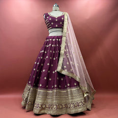 Wine raw silk lehenga set with blouse and net dupatta on mannequin