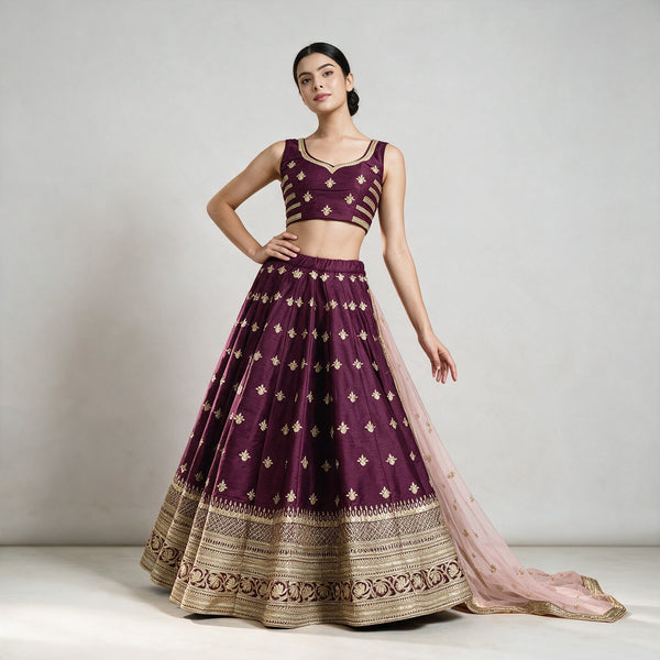 Wine maroon lehenga skirt with gold butti, sleeveless blouse, and net dupatta