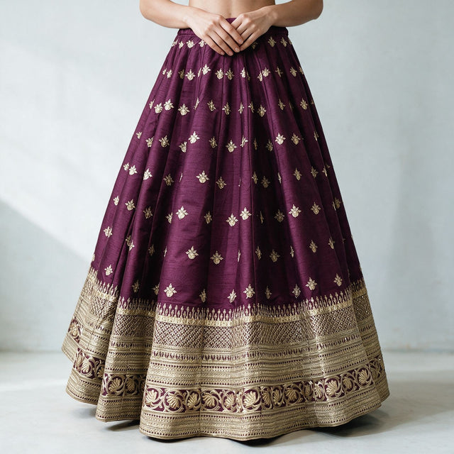 Wine raw silk lehenga skirt with scattered gold butis and layered gold embroidered hem