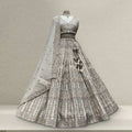 Off-white embroidered bridal lehenga with contrast dupatta, flared skirt and fitted bodice