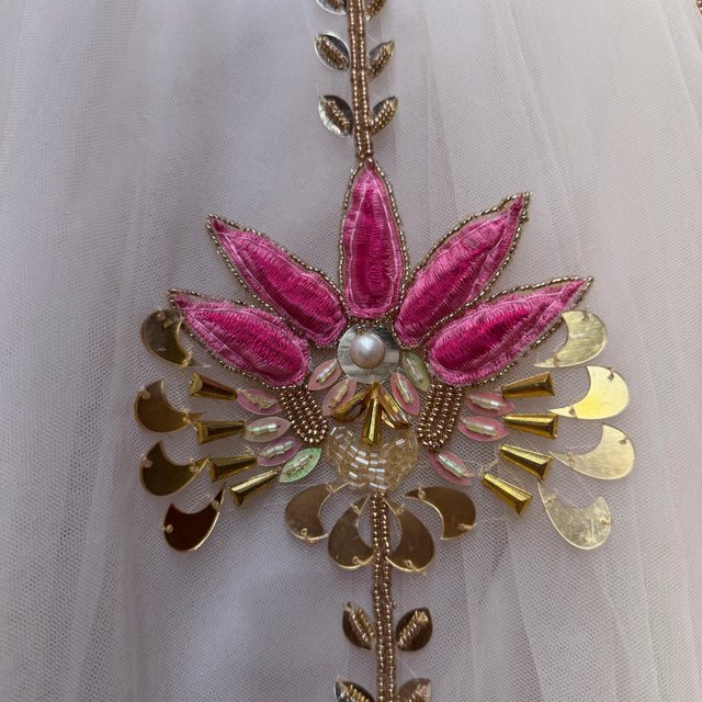 Pink and gold floral embroidery on sheer fabric with hanging bead