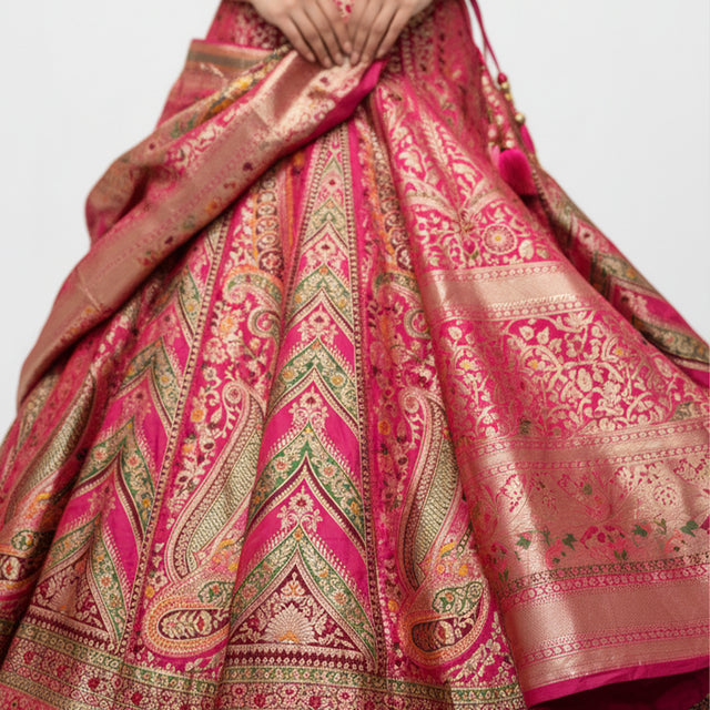 Pink Banarasi silk lehenga fabric with intricate woven border and motifs