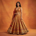 Haldi yellow silk flared lehenga with sleeveless blouse and draped dupatta