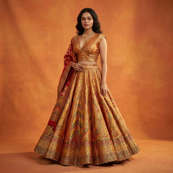 Haldi yellow silk flared lehenga with sleeveless blouse and draped dupatta