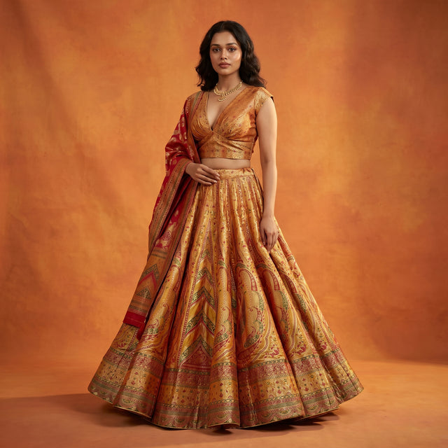 Haldi yellow silk flared lehenga with sleeveless blouse and draped dupatta