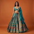 Rama green Banarasi silk flared lehenga with multicolor geometric motifs and dupatta