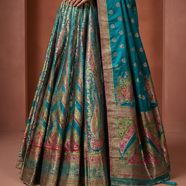 Flared lehenga skirt with teal base, ornate multicolor woven border and pleats