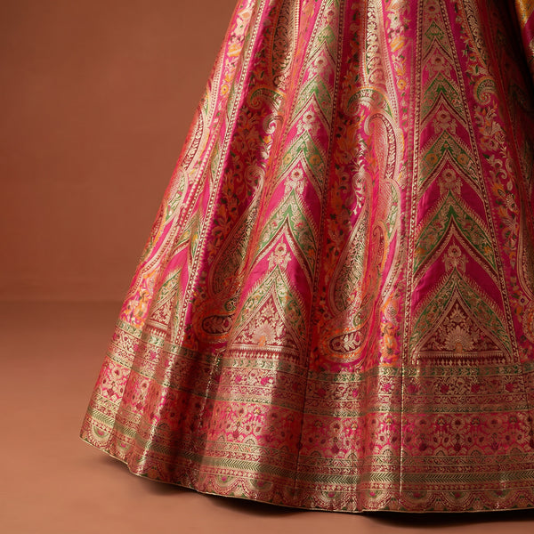 Flared lehenga skirt in pink and gold with intricate Patola-style woven motifs