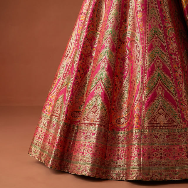 Flared lehenga skirt in pink and gold with intricate Patola-style woven motifs
