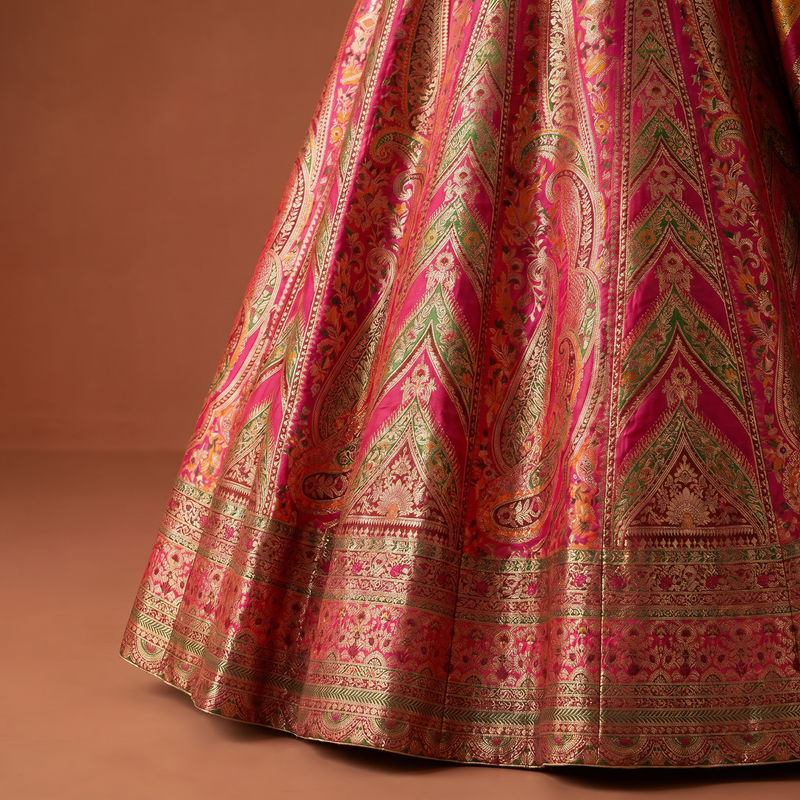 Pink and gold patterned lehenga skirt with intricate banded motif panels