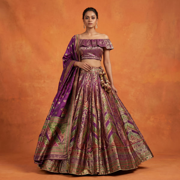 Wine and purple silk flared lehenga with ornate woven print and short off-shoulder blouse