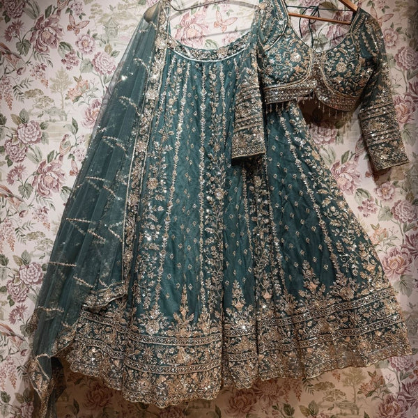 Teal net lehenga set with gold cutdana and sequin work, blouse and dupatta