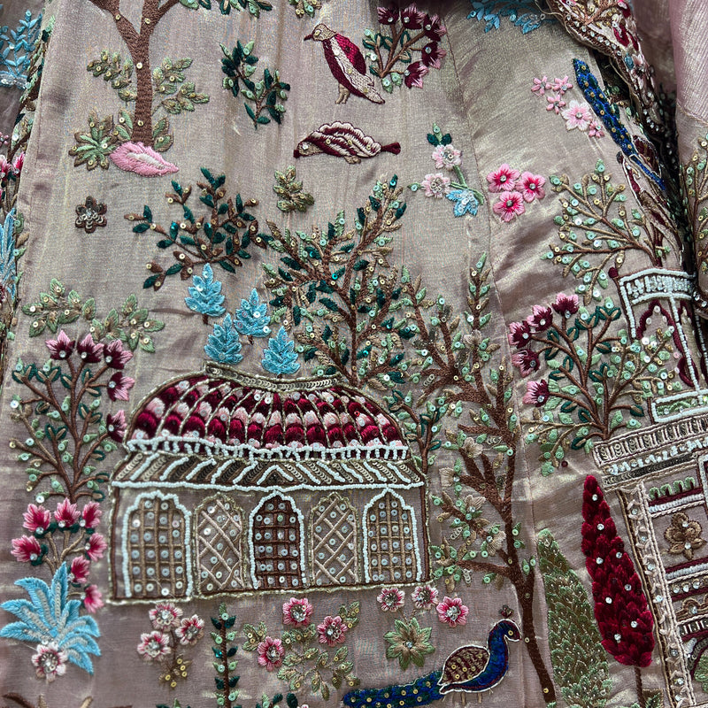 Embroidered lehenga fabric close-up with floral, tree, and temple motif details