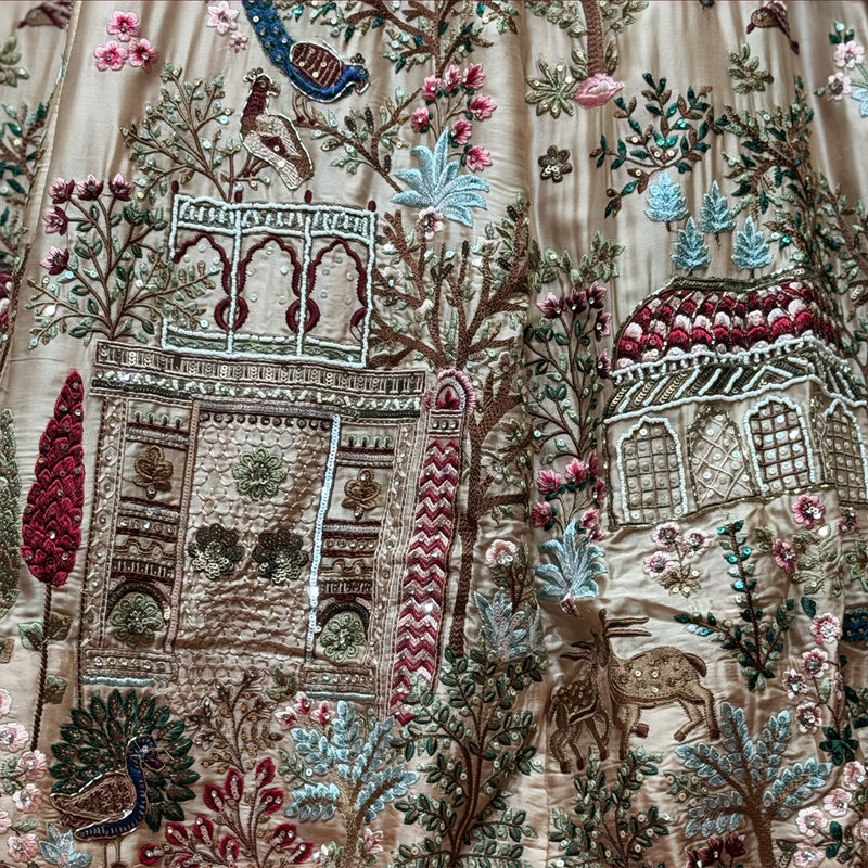 Close view of the peach lehenga showing moti beadwork raised over multicolour resham embroidery