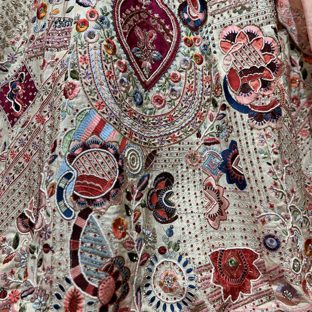 Ivory fabric with dense multicolour beaded motifs, mirror-like embellishments and embroidery
