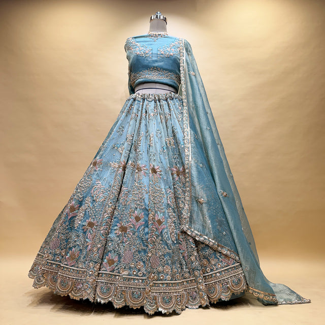 Powder blue lehenga with full gathered back and gold embroidered border hem