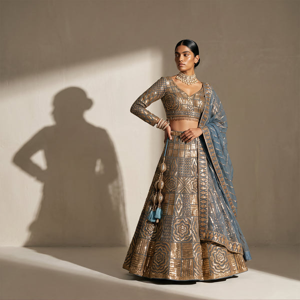 Teal blue lehenga set with gold embroidered crop blouse, long skirt and matching dupatta