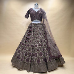 Maroon embroidered lehenga skirt with V-neck blouse and sheer dupatta, on mannequin