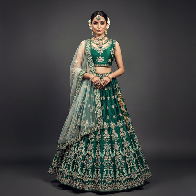 Deep green lehenga with gold-cream embroidery and sheer dupatta, matching choli