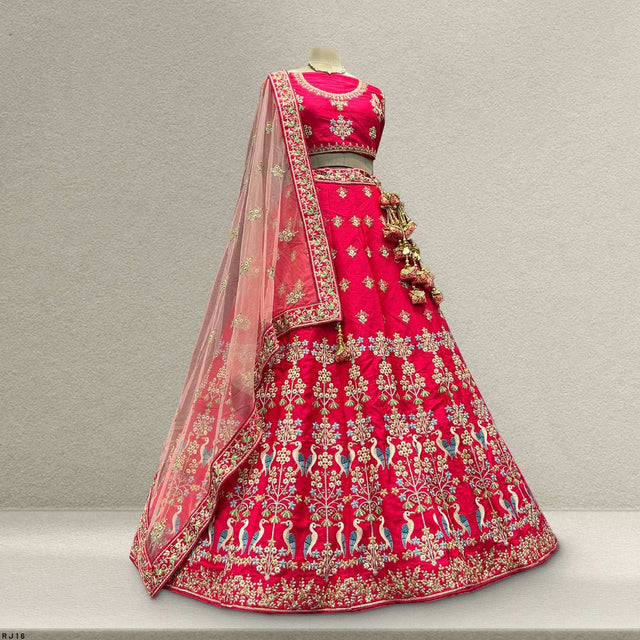 Pink raw silk lehenga on mannequin, gold embroidery with sheer dupatta drape