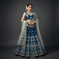 Blue raw silk lehenga with gold threadwork, floral crop blouse and sheer dupatta