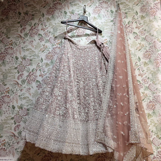 Lavender sequined lehenga on hanger with ornate beading and sheer dupatta drape