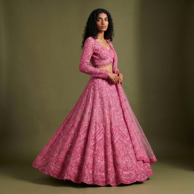 Shocking pink sequin lehenga with long-sleeve blouse and full tiered skirt