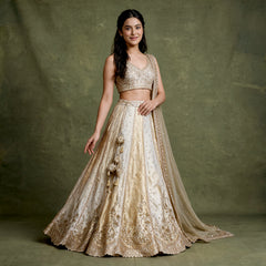 Offwhite lehenga set with gold cutdana embroidery, sleeveless blouse and flared skirt