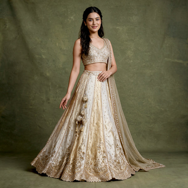 Offwhite lehenga set with gold cutdana embroidery, sleeveless blouse and flared skirt