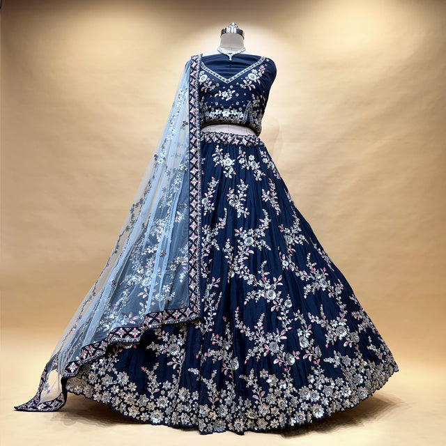 Navy lehenga skirt with silver zari floral motifs, paired with embroidered blouse and dupatta