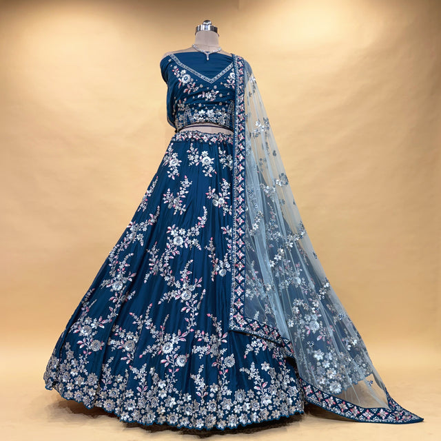 Blue lehenga on mannequin with silver floral embroidery, belt waist, and sheer dupatta