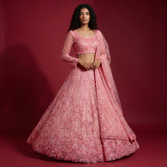 Baby pink sequin lehenga with long-sleeve blouse and tiered flared skirt